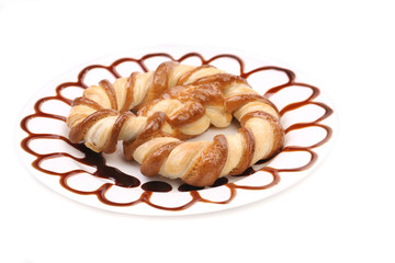 Delicious knot-shaped biscuits on plate.