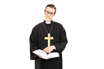 Male priest pointing to a paragraph of the bible