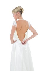 Bride getting dressed against white background