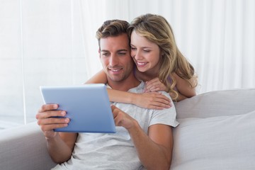 Young couple using digital tablet together