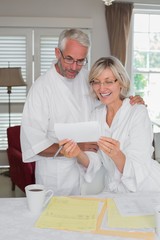 Obraz premium Mature couple looking at a document at home