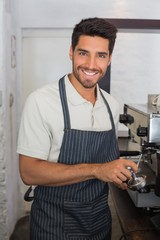 Fototapeta na wymiar Waiter smiling and making cup of coffee at coffee shop