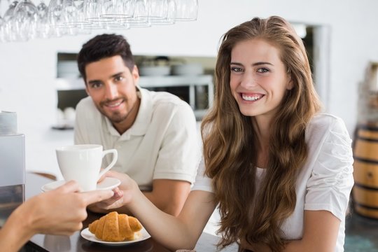 Hand Giving Coffee To A Couple At Coffee Shop