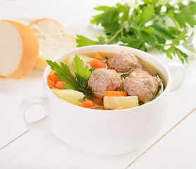 Meatball soup in white bowl