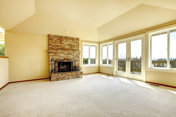 Empty living room with a fireplace and walkout deck