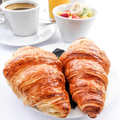 Breakfast with coffee and croissants