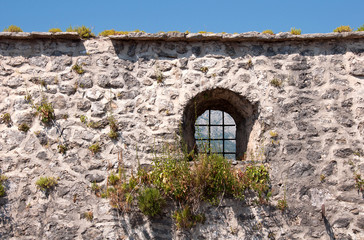 Medieval stone wall with small window