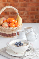 Healthy breakfast: oats porridge with coffee on the table