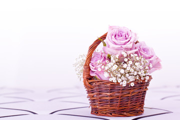 pink roses in brown basket of withe background