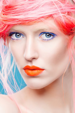 Portrait of beautiful girl with pink hair and orange lips