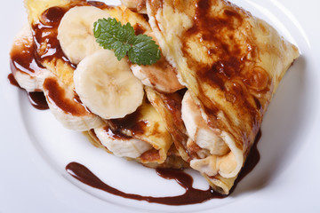 banana crepes with chocolate top view