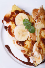 banana crepes with chocolate view from above. Vertical