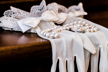 White gloves bride on wooden table