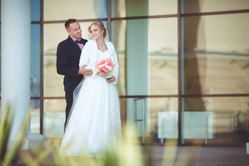 Naklejka premium Bride and groom at wedding day kissing at park