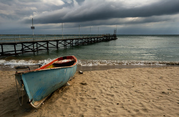 Boat on cloudy beach - 62545112