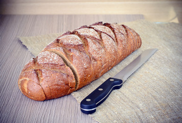 Fresh Tasty Bread on Woody Background