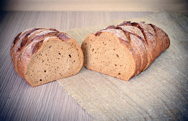 Fresh Tasty Bread on Woody Background