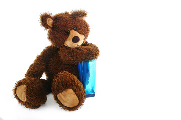 Teddy bear with a blue transparent glass