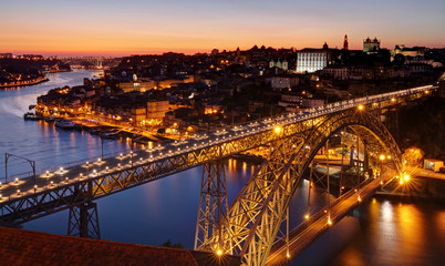 Fototapeta na wymiar Oporto at river Douro and Dom Luis bridge after sunset