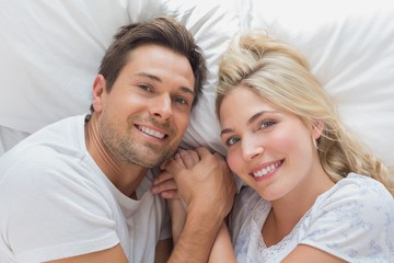 High angle portrait of a couple lying in bed