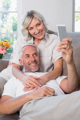 Fototapeta premium Mature couple photographing themselves with cellphone