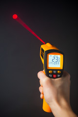 infrared laser thermometer in hand