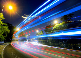 Fototapeta na wymiar Busy traffic on road at night