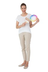 Young woman with paint samples and paintbrush