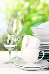 Clean dishes on table on natural background
