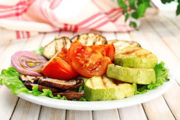 Delicious grilled vegetables on plate on table close-up