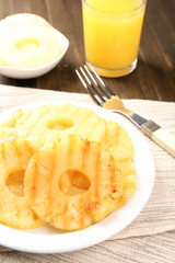 Juicy grilled pineapple on plate on table close-up