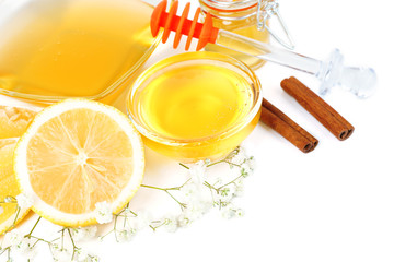 Sweet honey with lemon isolated on white