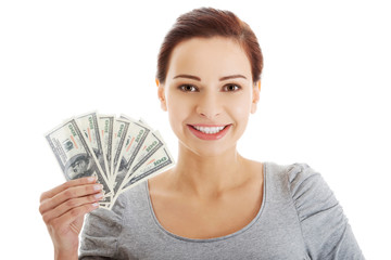 Casual woman holding money.
