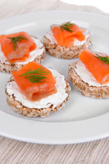 Delicious canapes on plate close-up