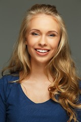 Naklejka premium Positive young woman with long hair and blue eyes