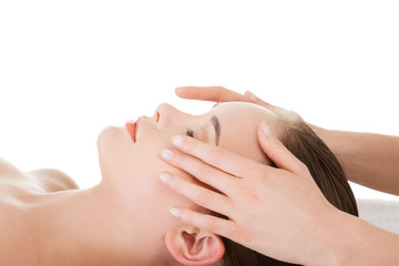 Relaxed woman enjoy receiving face massage