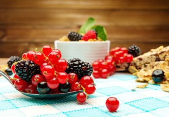 Healthy breakfast with muesli and berries on tablecloth 