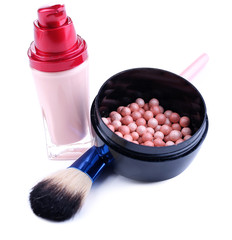 Composition with concealer, powder balls and brush isolated