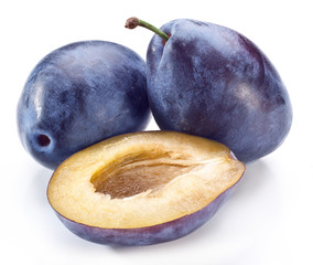 Plums with half of one.