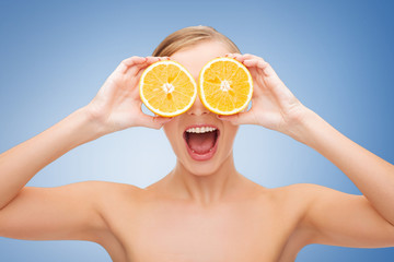 amazed young woman with orange slices