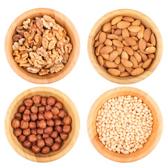Different nuts in wooden bowls isolated on white background