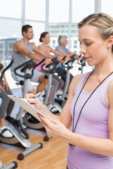 Fototapeta premium Trainer with people working out at spinning class