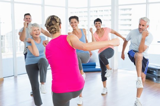 People doing power fitness exercise at yoga class in fitness