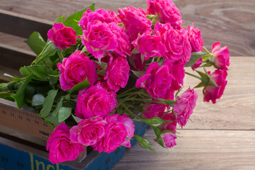 pink roses on wooden table