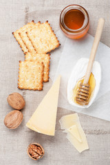 Fototapeta na wymiar Camembert and parmesan cheese, honey and nuts