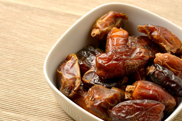 A photo of a pile of dates in a bowl