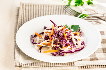 Healthy salad with green, red cabbage and carrot