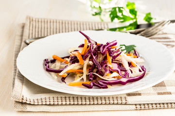 Healthy salad with green, red cabbage and carrot
