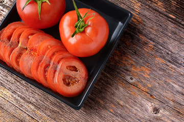 Fresh tomatoes sliced ​​and whole