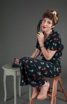 Pinup Girl Looks Exasperated While on Old-Fashioned Telephone